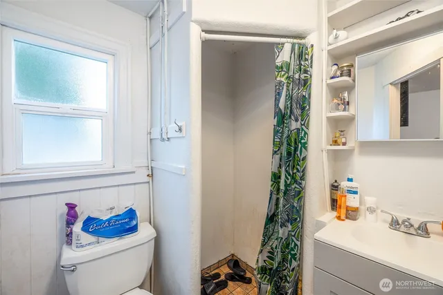 a bathroom with a toilet a sink and a window