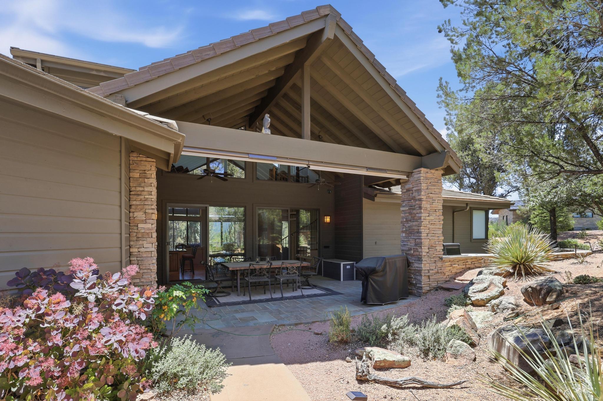 2908 East Rim Club Drive Payson, AZ 85541 - Photo 66 of 77 a view of a porch with chairs and potted plants
