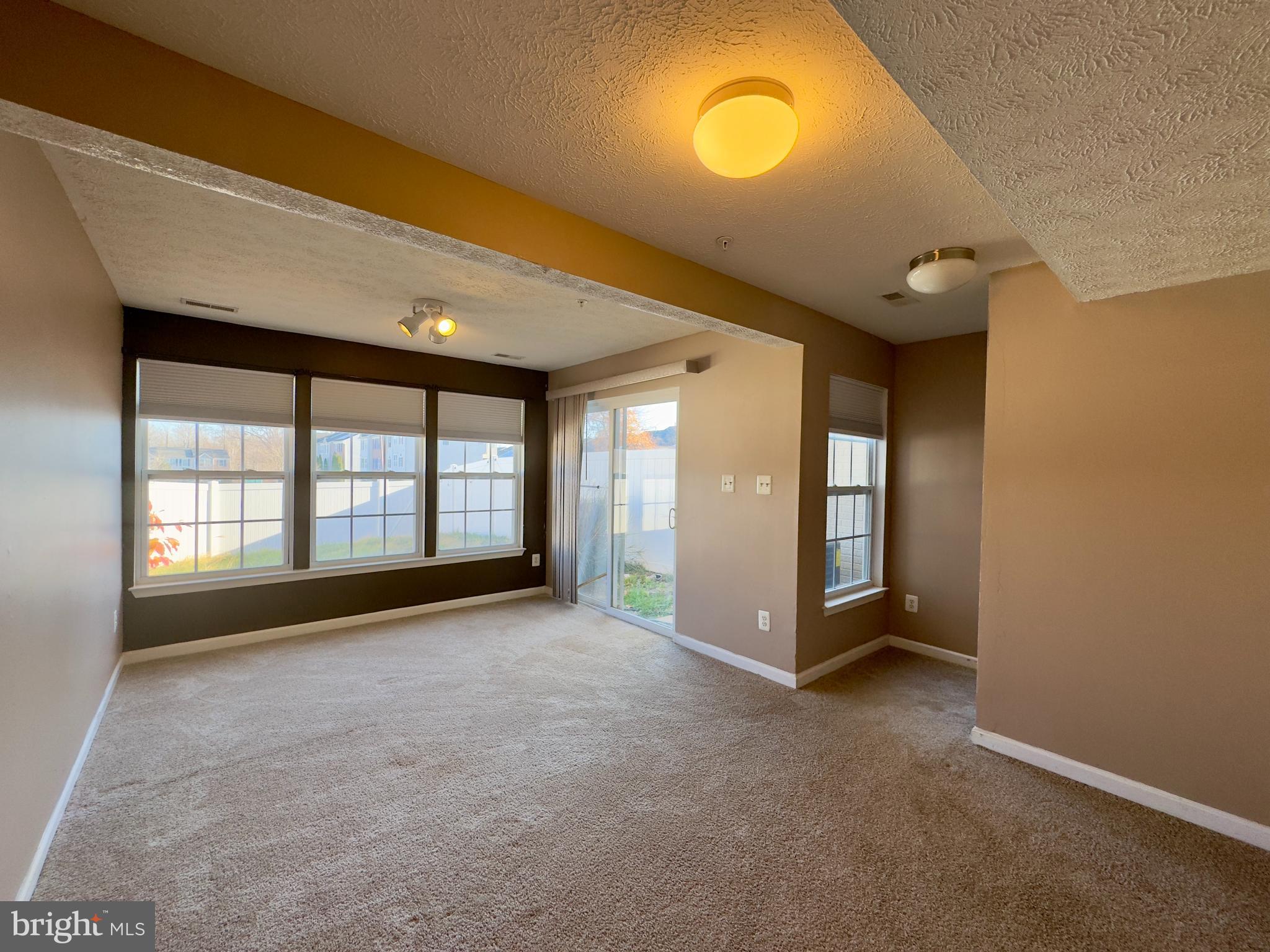 657 Possum Trot Way Aberdeen, MD 21001 - Photo 16 of 25 a view of an empty room with a fireplace and a window