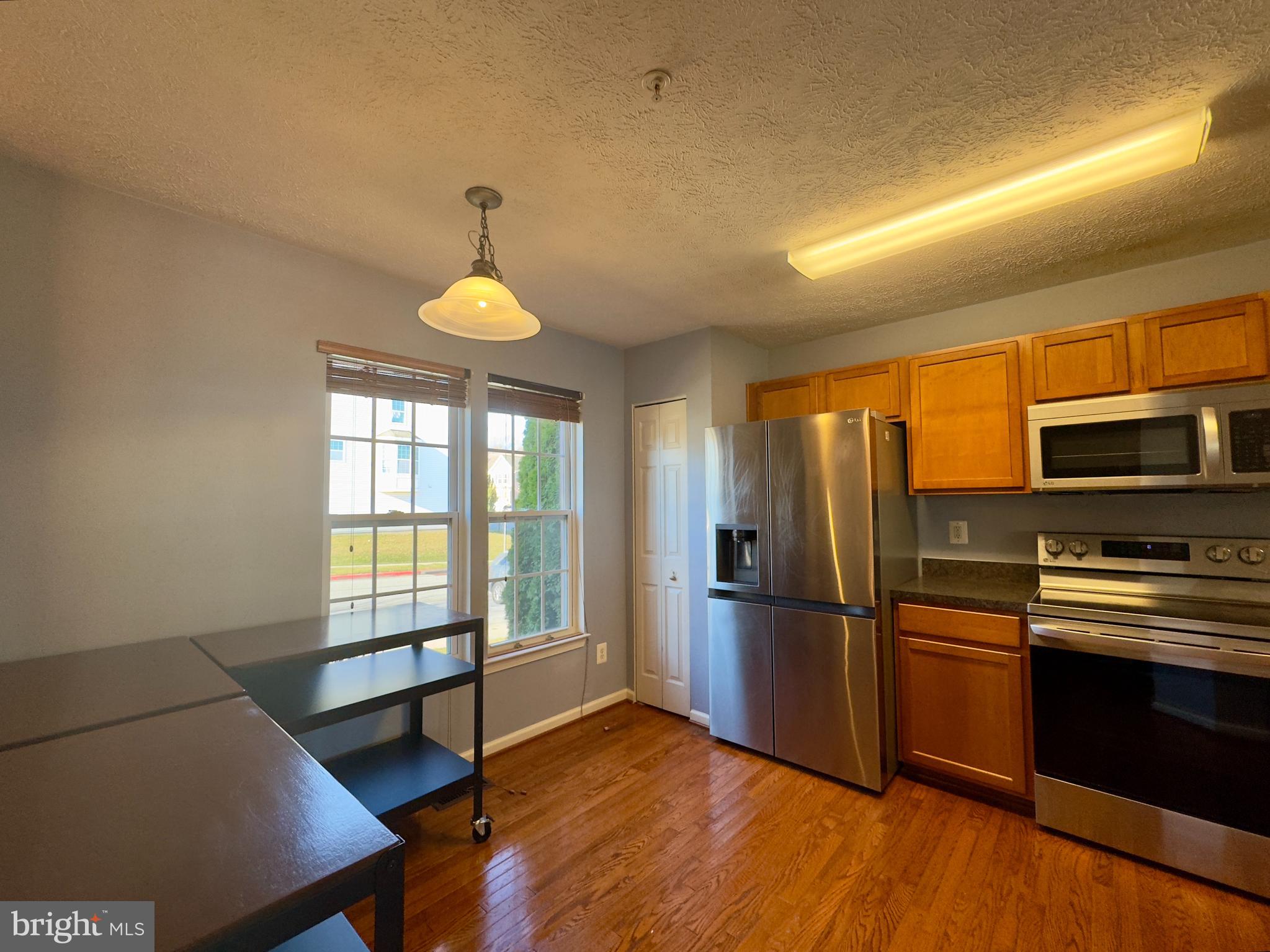 657 Possum Trot Way Aberdeen, MD 21001 - Photo 21 of 25 a kitchen with stainless steel appliances a refrigerator and a stove top oven