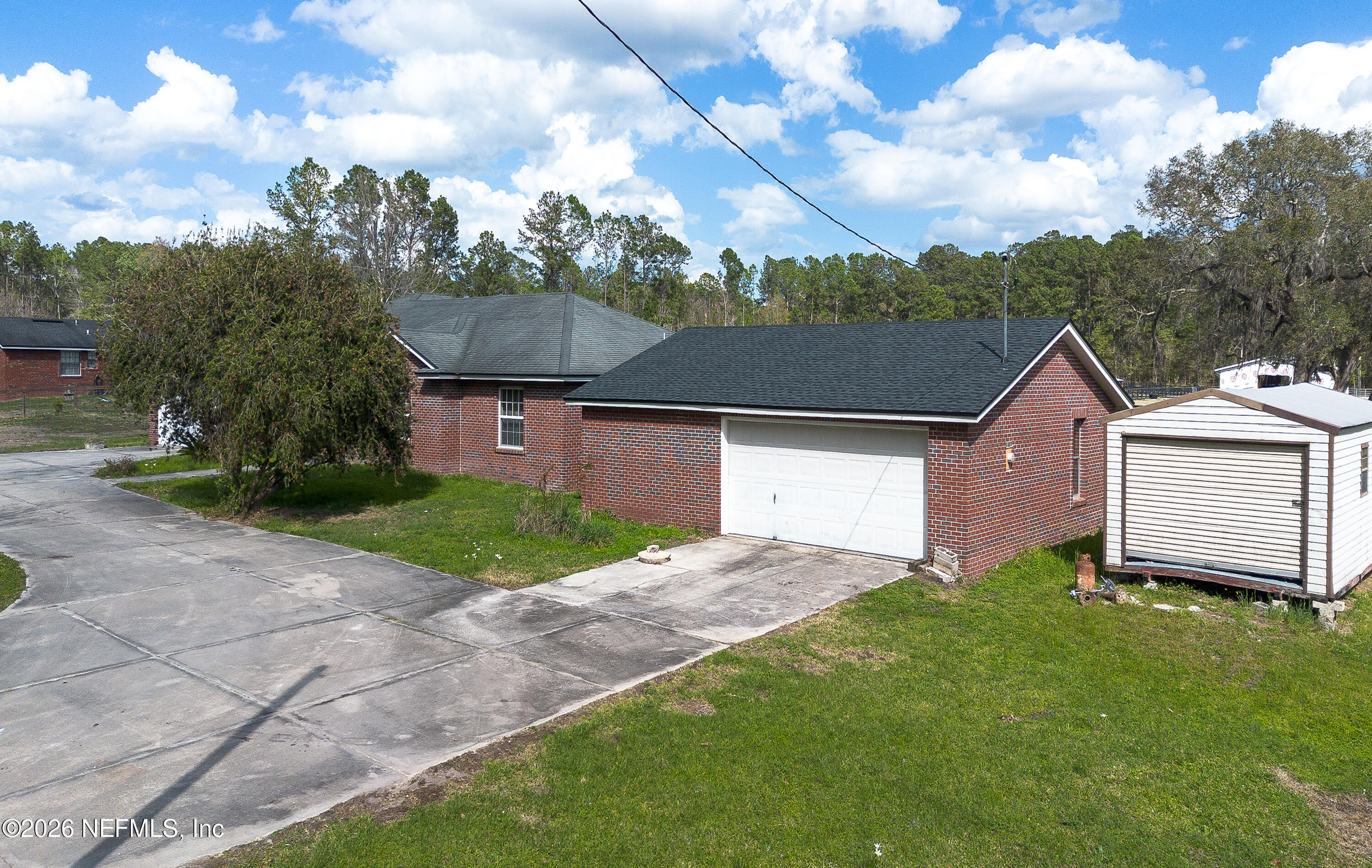 4333 Hawk Haven Road Middleburg, FL 32068 - Photo 22 of 51 a front view of a house with a yard and garage