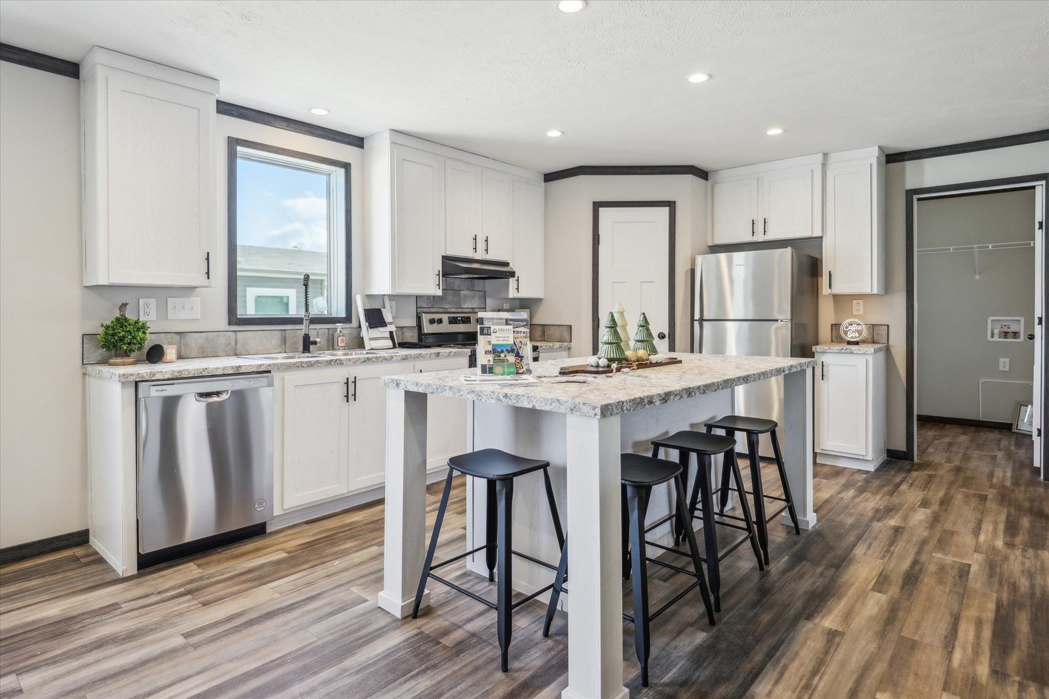 4046 Hinge Gate Lane Memphis, TN 38128 - Photo 6 of 24 a kitchen with stainless steel appliances a dining table chairs stove refrigerator and cabinets