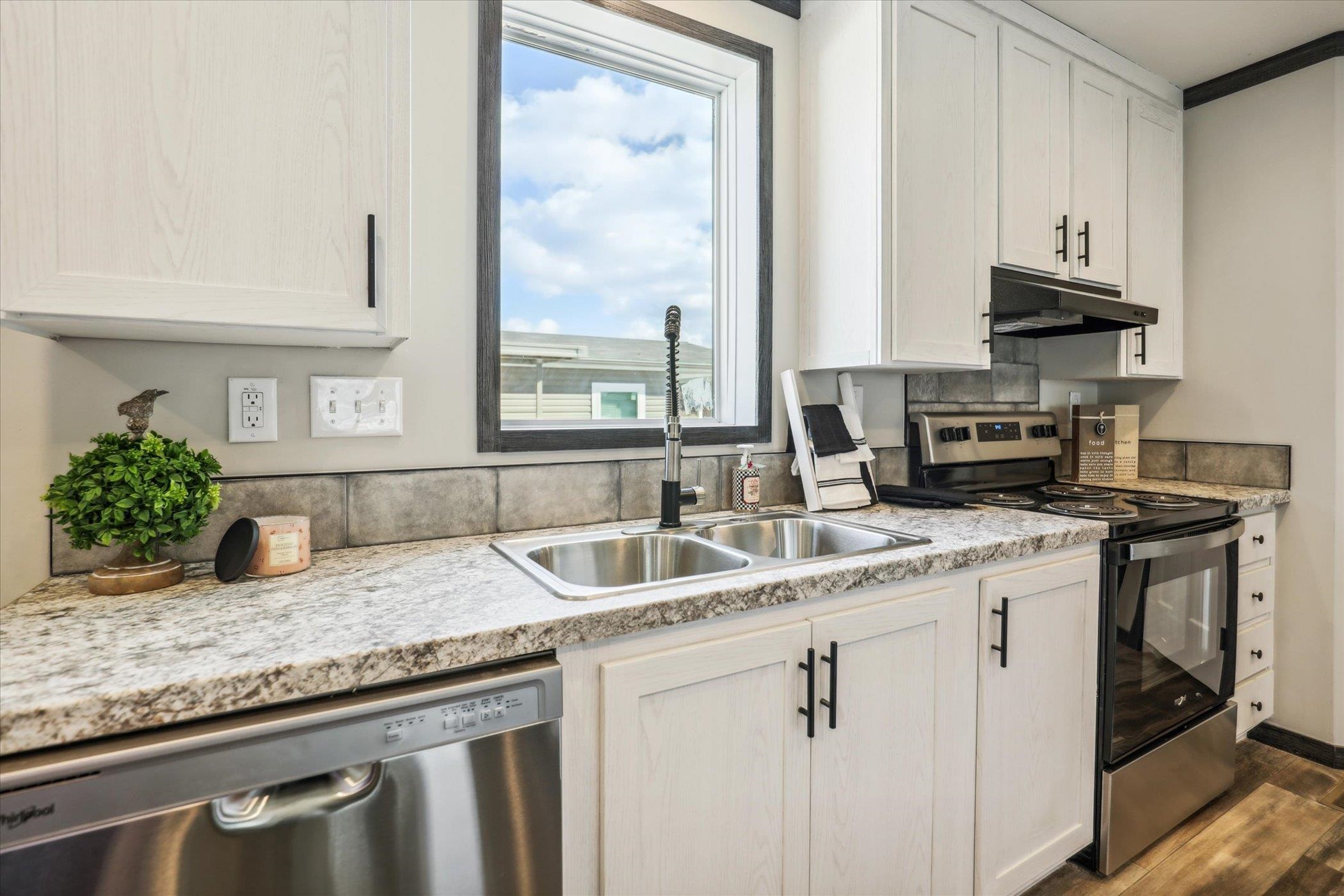 4046 Hinge Gate Lane Memphis, TN 38128 - Photo 9 of 24 a kitchen with stainless steel appliances granite countertop a sink a stove and a granite counter tops