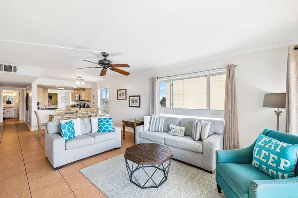 a kitchen with granite countertop lots of counter top space a sink a stove and cabinets