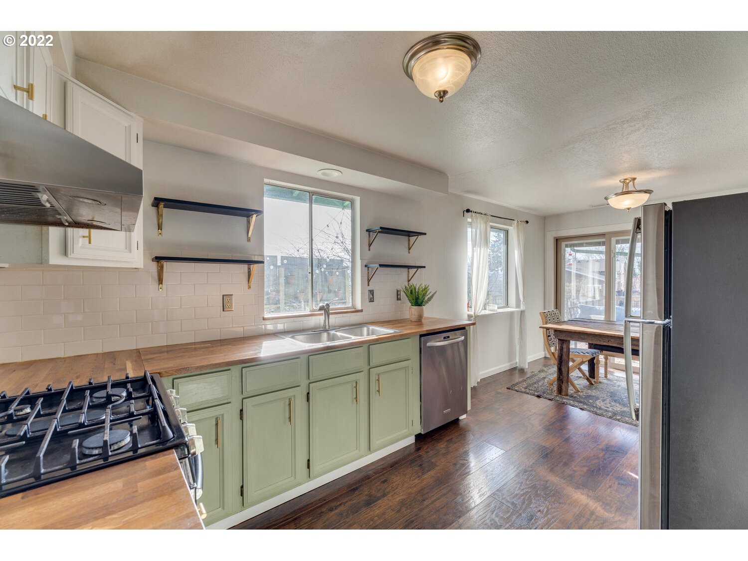 211 South 5th Avenue Ridgefield, WA 98642 - Photo 5 of 16 a kitchen with lots of counter top space and dining table