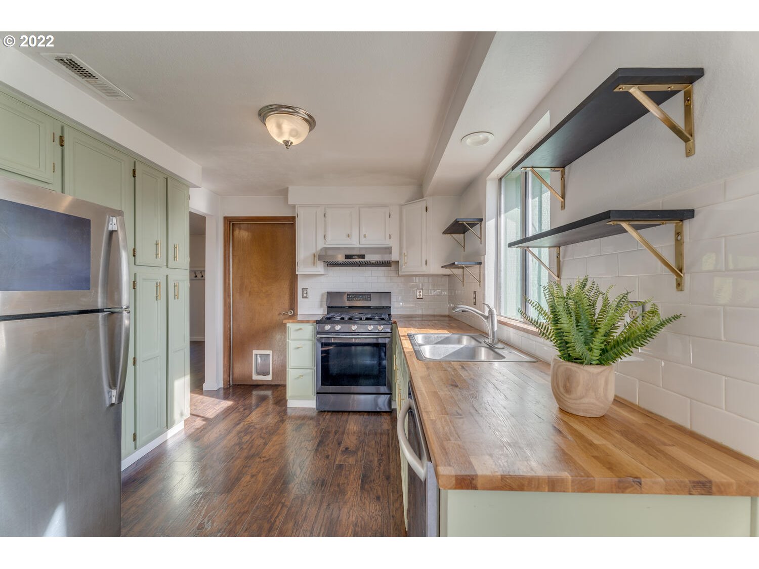 211 South 5th Avenue Ridgefield, WA 98642 - Photo 6 of 16 a kitchen with kitchen island a counter top space a refrigerator and a stove