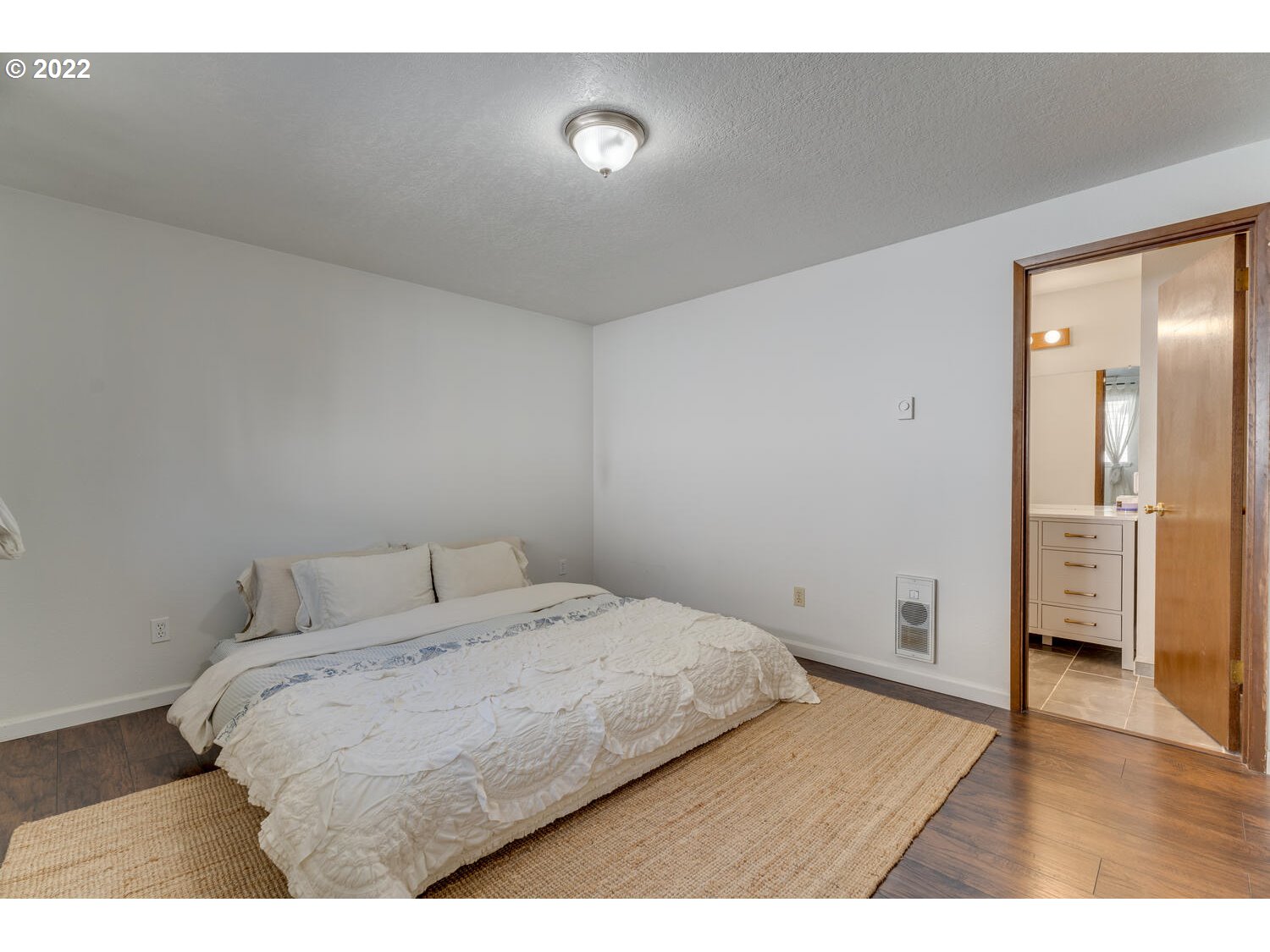 211 South 5th Avenue Ridgefield, WA 98642 - Photo 8 of 16 a bedroom with a bed and wooden floor
