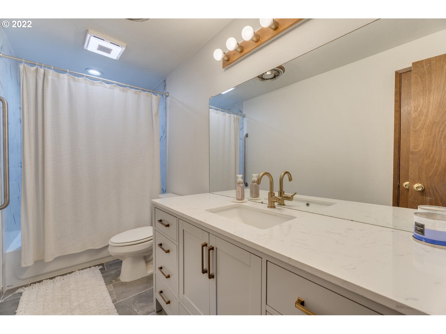 211 South 5th Avenue Ridgefield, WA 98642 - Photo 9 of 16 a bathroom with a sink a toilet and a mirror