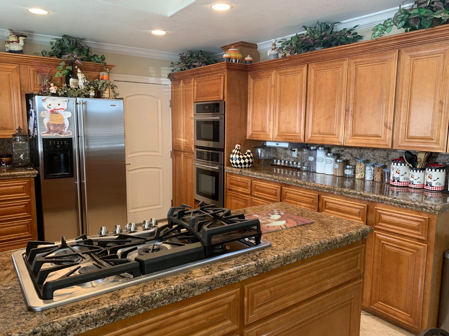461 Soledad Street Soledad, CA 93960 - Photo 12 of 21 a kitchen with stainless steel appliances granite countertop a sink stove and refrigerator