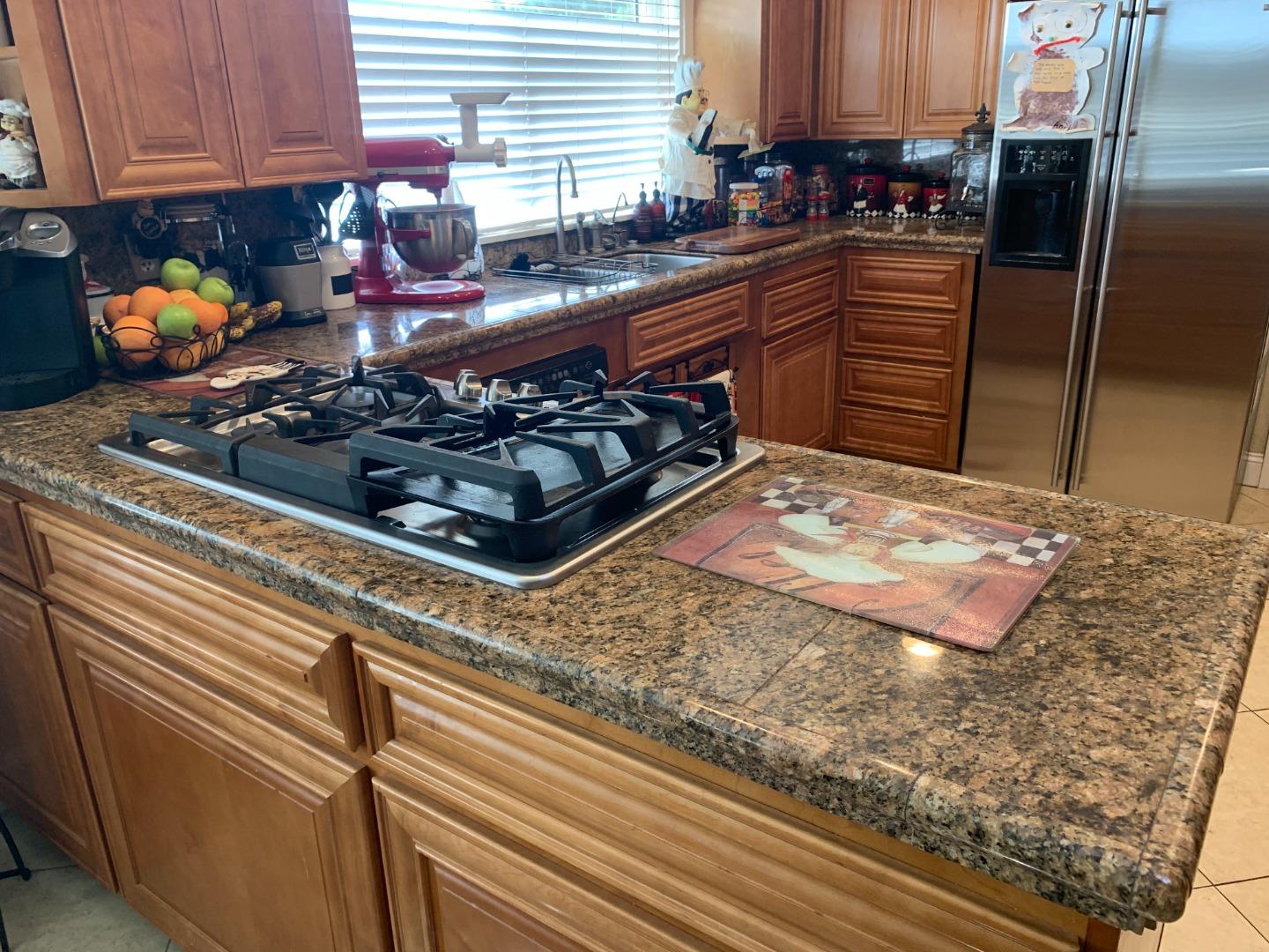 461 Soledad Street Soledad, CA 93960 - Photo 13 of 21 a kitchen with a stove a sink and a refrigerator