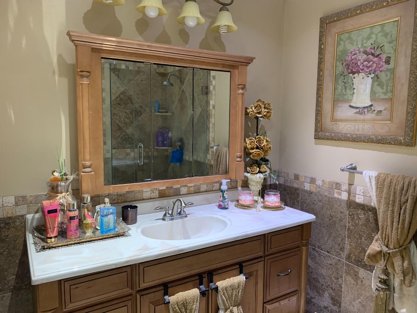 461 Soledad Street Soledad, CA 93960 - Photo 15 of 21 a bathroom with a sink and a mirror