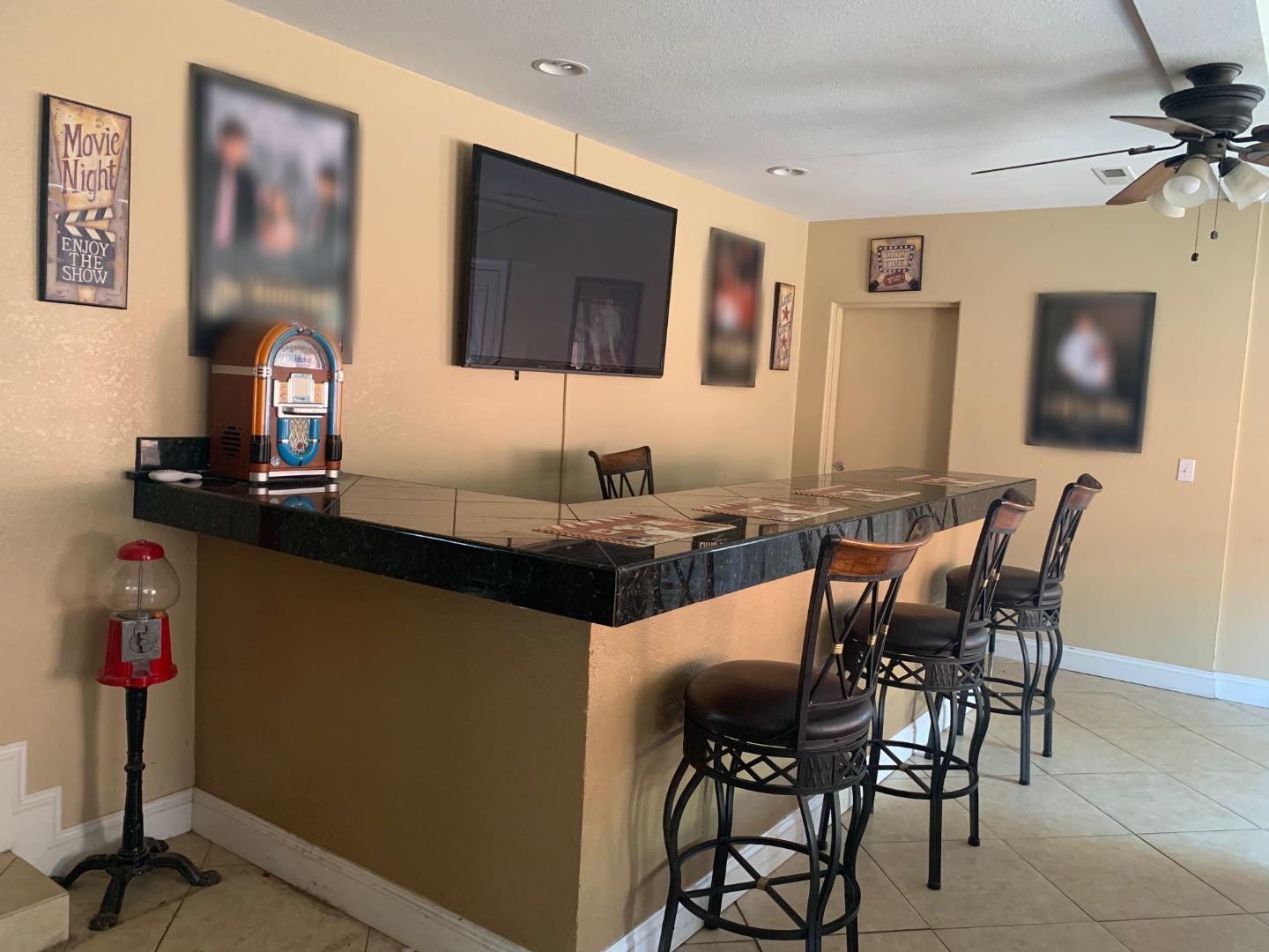 461 Soledad Street Soledad, CA 93960 - Photo 19 of 21 a view of a dining room with furniture and a flat screen tv