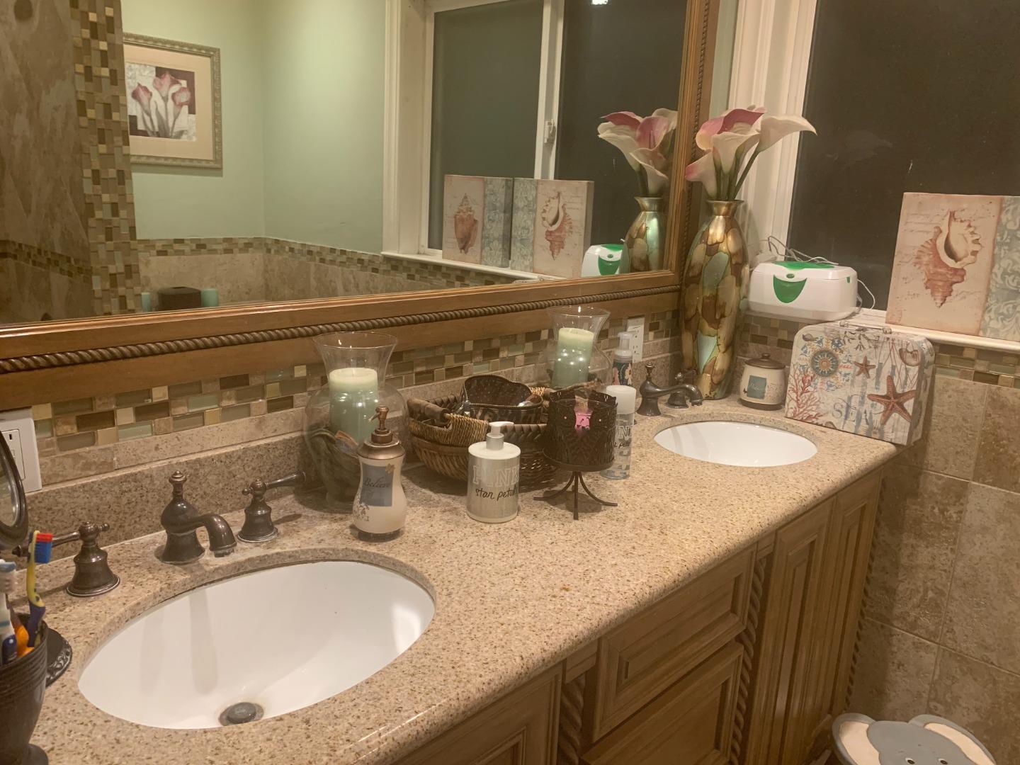 461 Soledad Street Soledad, CA 93960 - Photo 10 of 21 a bathroom with a granite countertop sink and a mirror