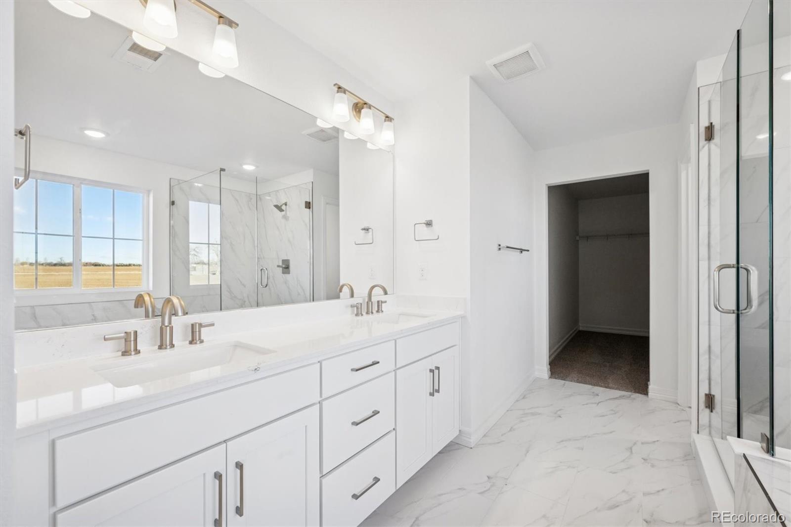 6120 Oban Road Timnath, CO 80547 - Photo 15 of 22 a bathroom with double sink and a mirror