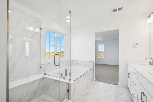 a bathroom with a tub sink and mirror