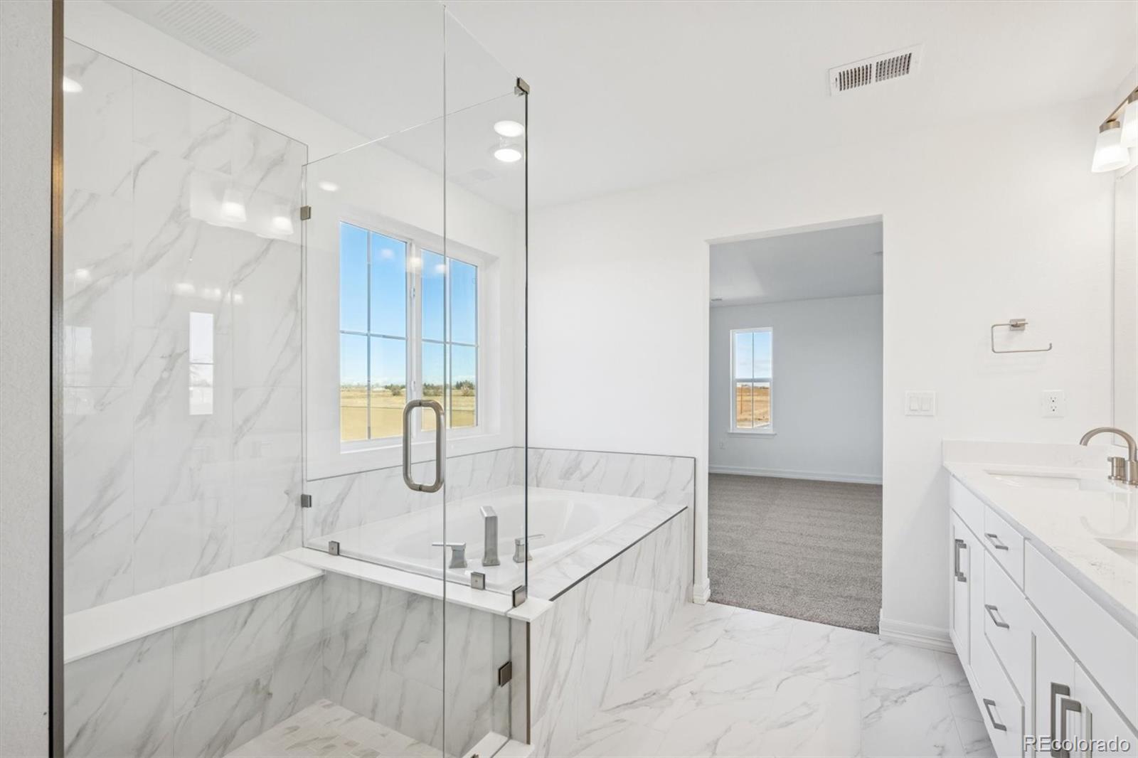 6120 Oban Road Timnath, CO 80547 - Photo 16 of 22 a bathroom with a tub sink and mirror