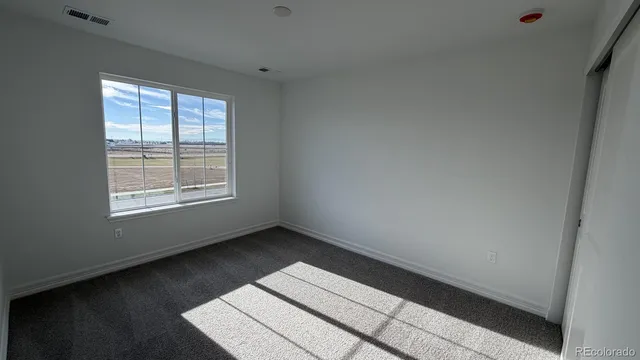 an empty room with a empty space and windows