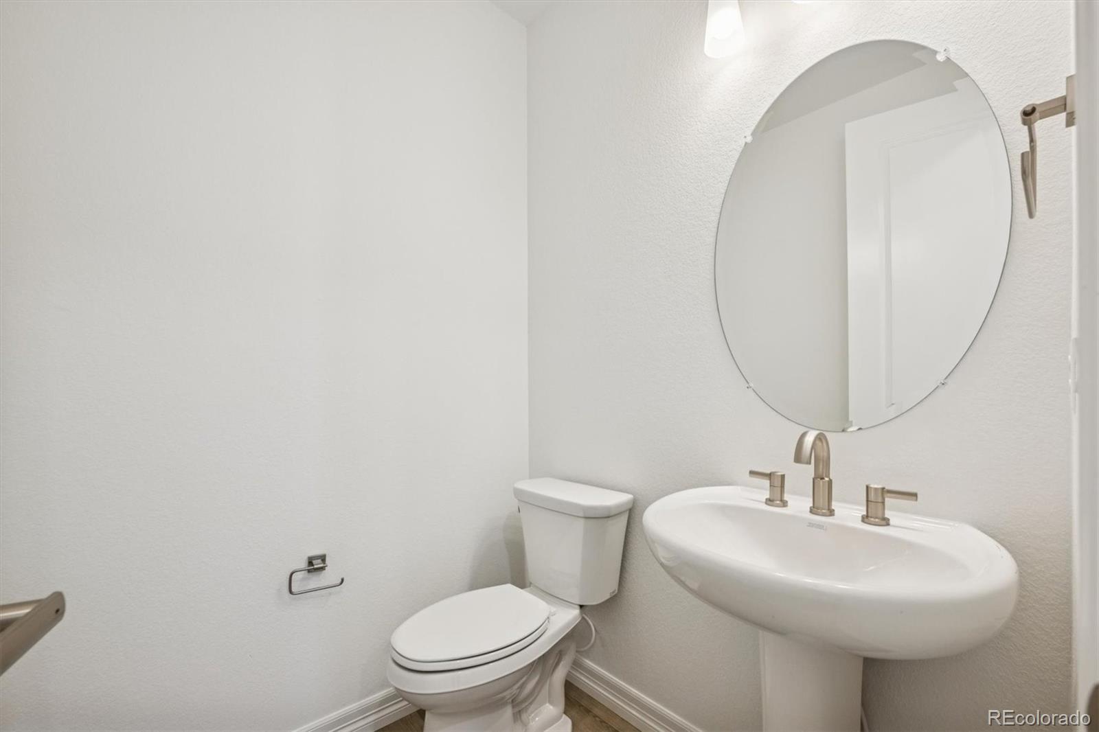 6120 Oban Road Timnath, CO 80547 - Photo 3 of 22 a bathroom with a sink a toilet and a mirror