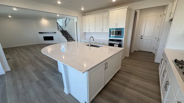 a view of kitchen with sink and wooden floor