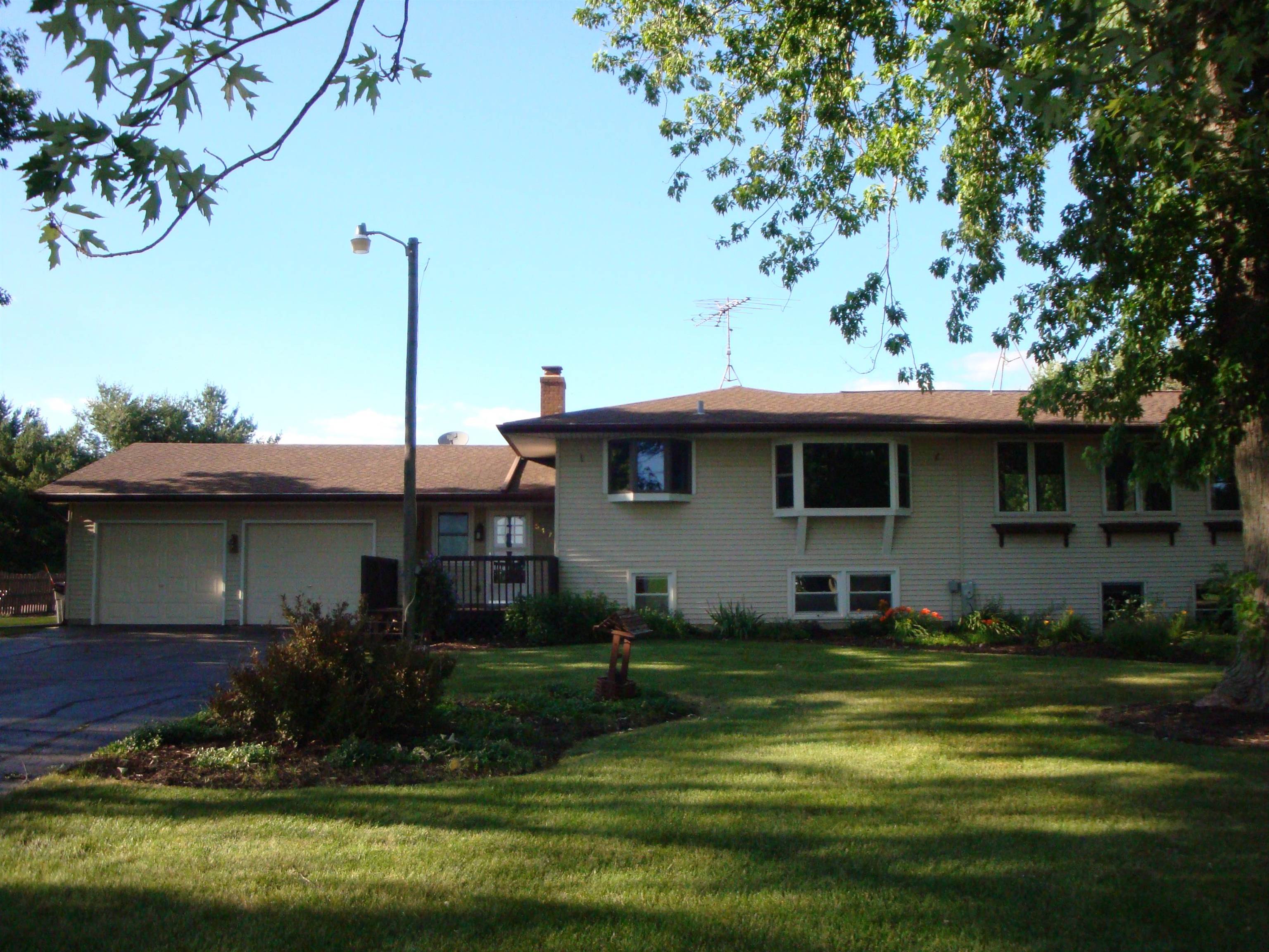 5178 Shattuck Road Belvidere, IL 61008 - Photo 2 of 46 a front view of a house with a garden
