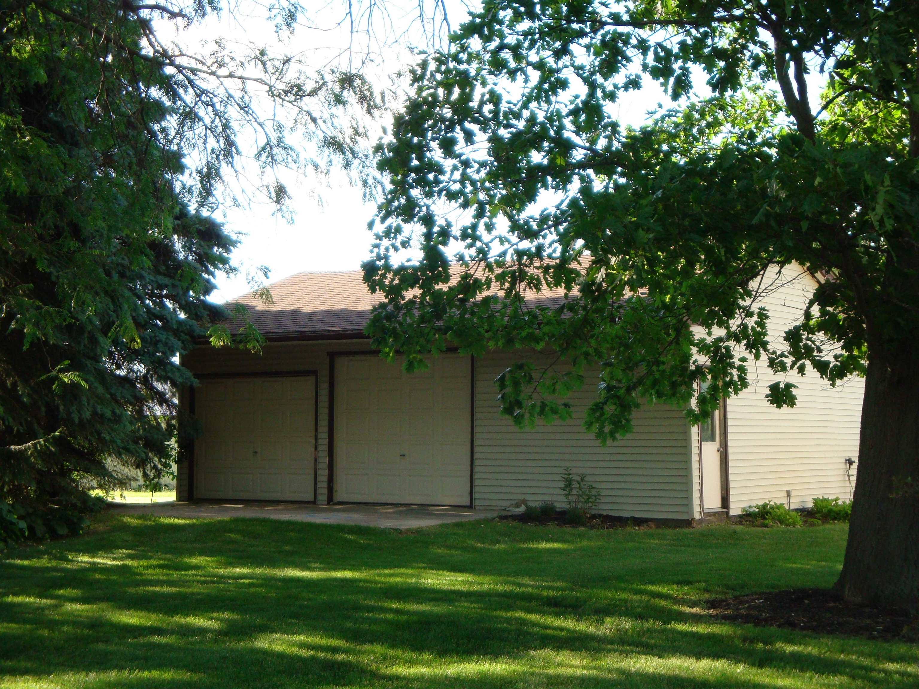 5178 Shattuck Road Belvidere, IL 61008 - Photo 3 of 46 a backyard of a house with plants and large tree