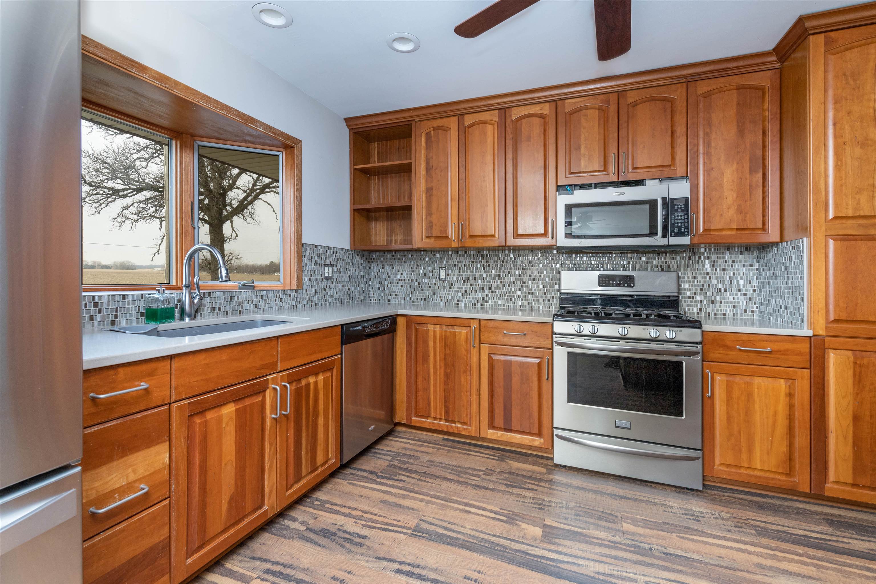 5178 Shattuck Road Belvidere, IL 61008 - Photo 10 of 46 a kitchen with stainless steel appliances granite countertop a stove microwave and sink