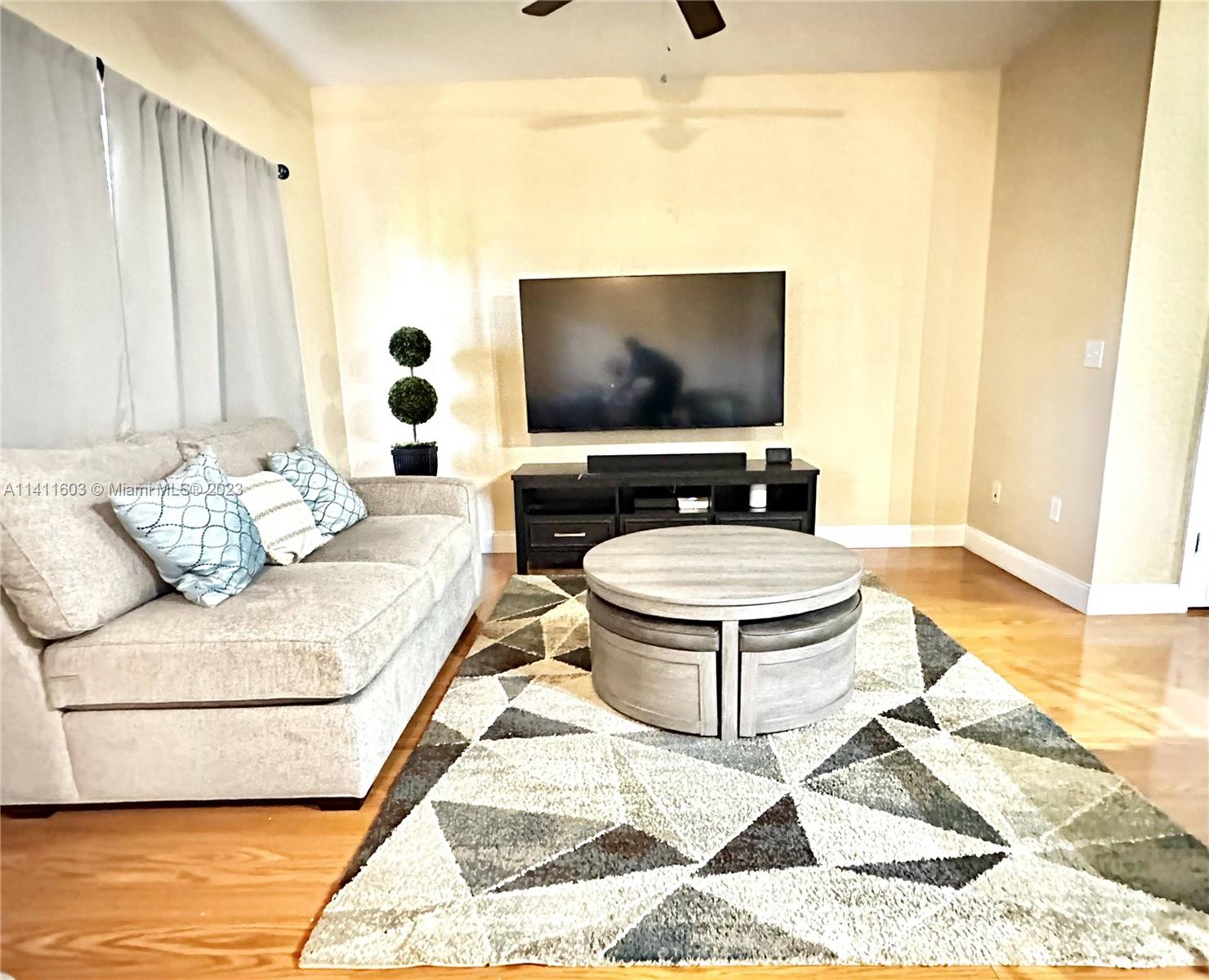 4322 Emerald Vista Lake Worth, FL 33461 - Photo 16 of 40 a living room with furniture and a flat screen tv