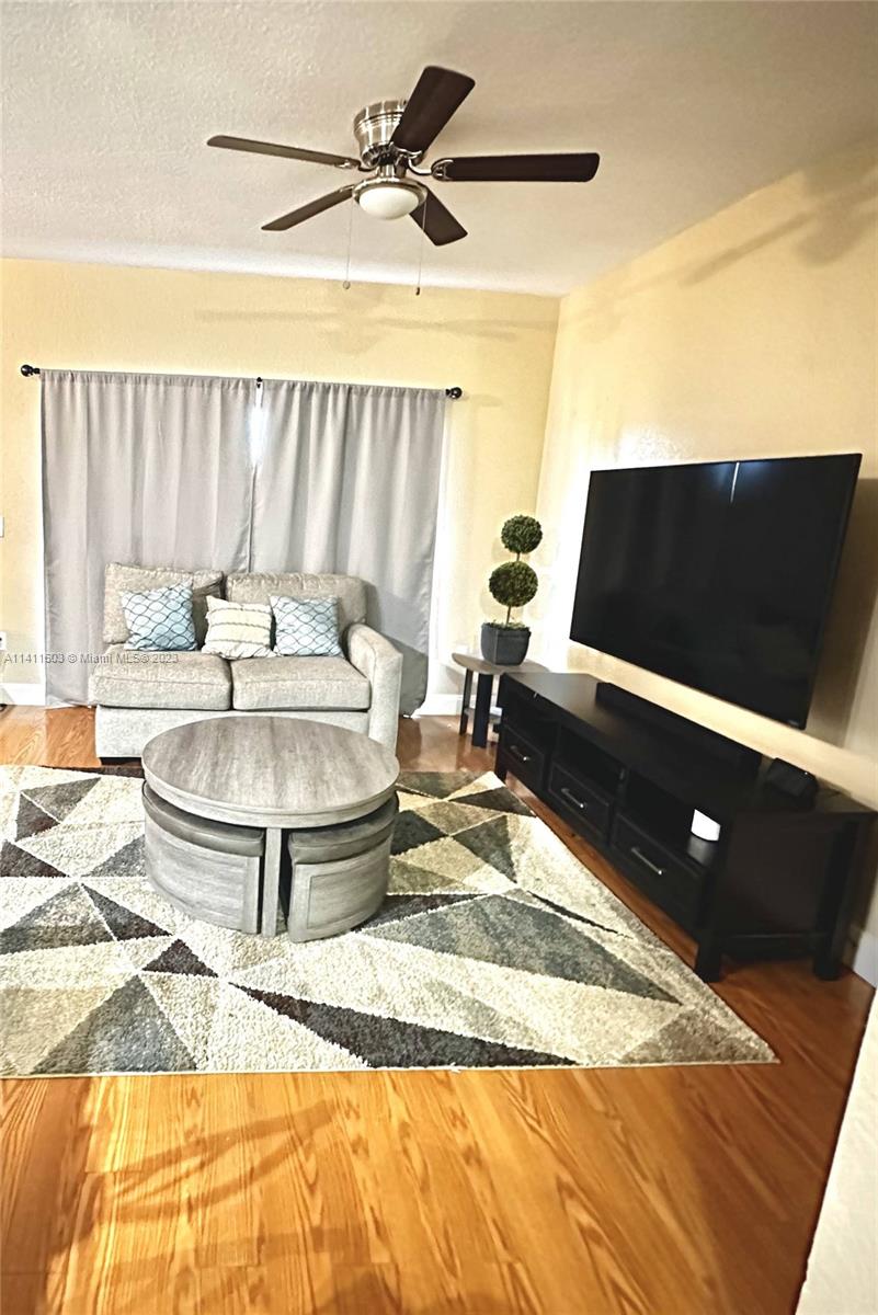 4322 Emerald Vista Lake Worth, FL 33461 - Photo 17 of 40 a living room with a flat screen tv and a couch