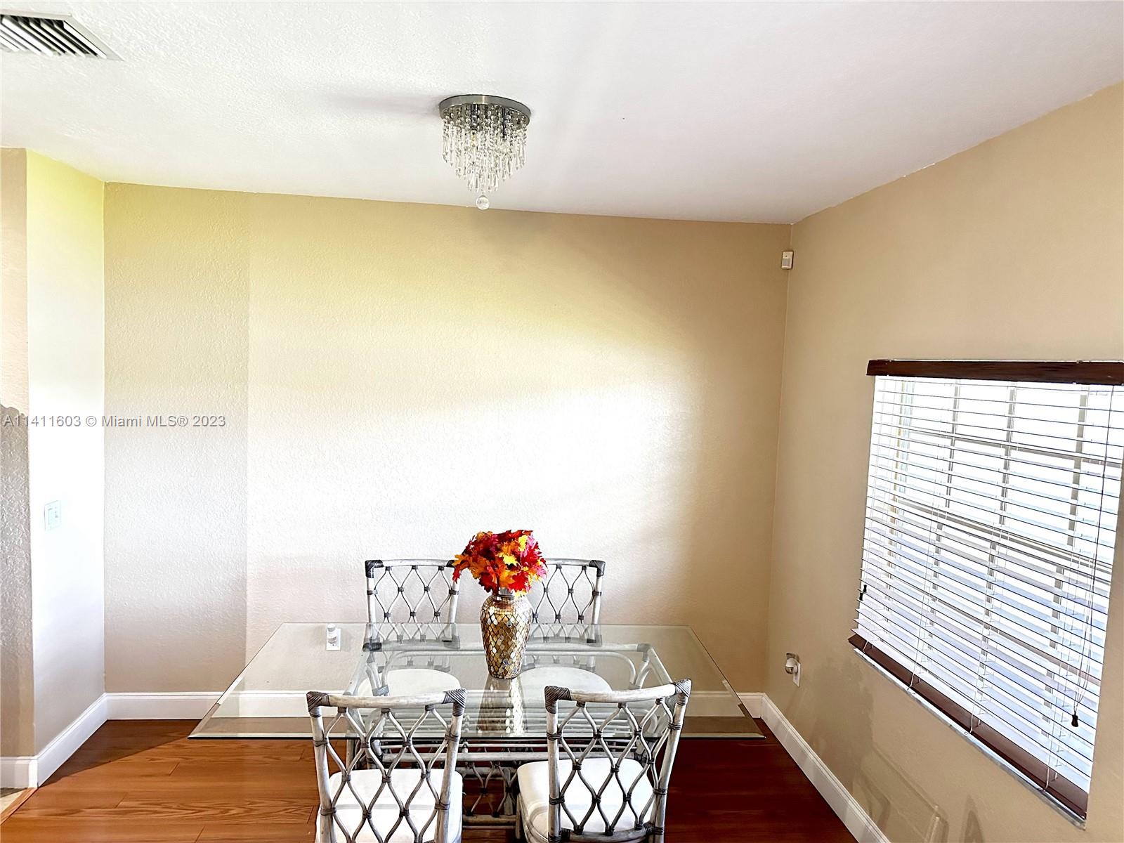 4322 Emerald Vista Lake Worth, FL 33461 - Photo 26 of 40 a dining room with furniture and wooden floor