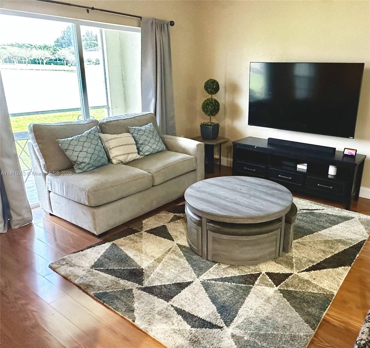 4322 Emerald Vista Lake Worth, FL 33461 - Photo 28 of 40 a living room with furniture and a flat screen tv