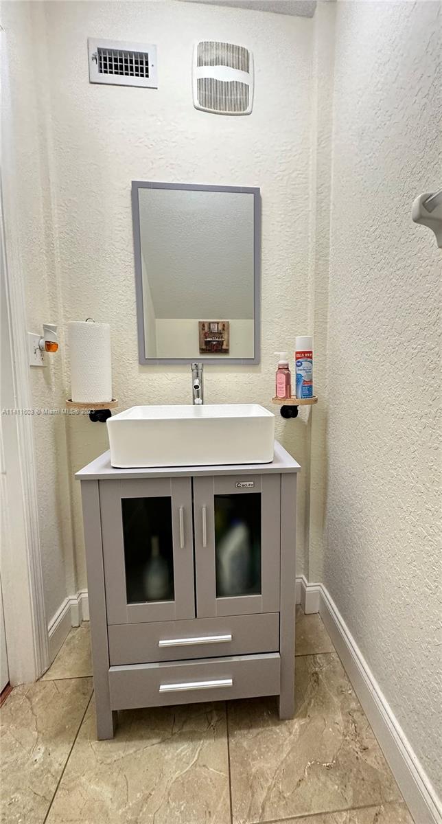 4322 Emerald Vista Lake Worth, FL 33461 - Photo 30 of 40 a bathroom with a sink and a mirror