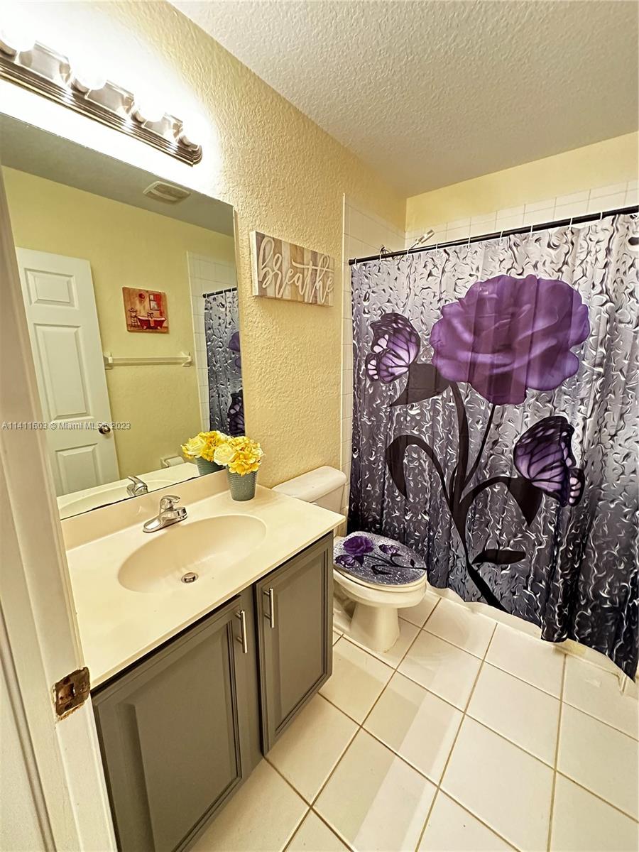 4322 Emerald Vista Lake Worth, FL 33461 - Photo 34 of 40 a bathroom with a sink and a mirror