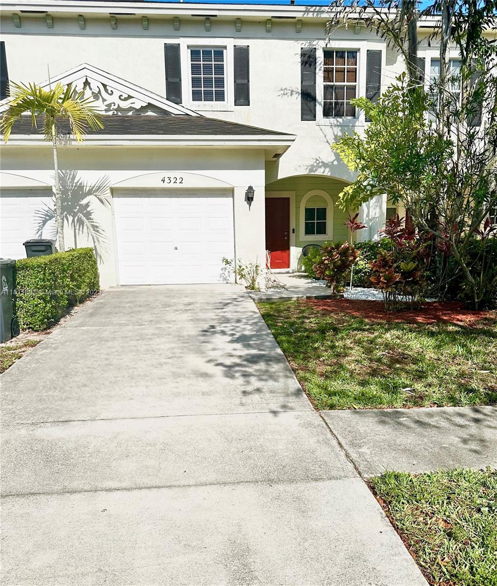 4322 Emerald Vista Lake Worth, FL 33461 - Photo 36 of 40 a front view of a house with garden