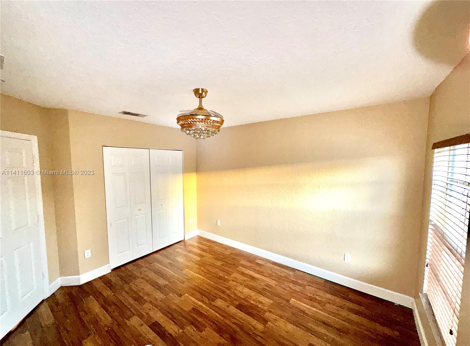 4322 Emerald Vista Lake Worth, FL 33461 - Photo 37 of 40 a view of empty room with wooden floor and fan