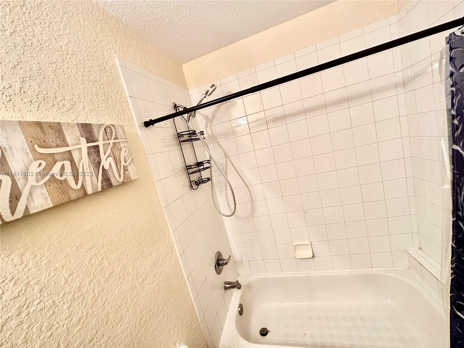 4322 Emerald Vista Lake Worth, FL 33461 - Photo 38 of 40 a bathroom with a shower and a bathtub