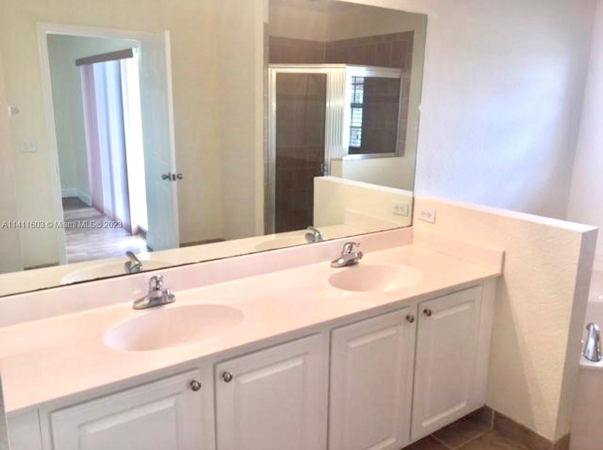 4322 Emerald Vista Lake Worth, FL 33461 - Photo 5 of 40 a bathroom with a sink and a mirror