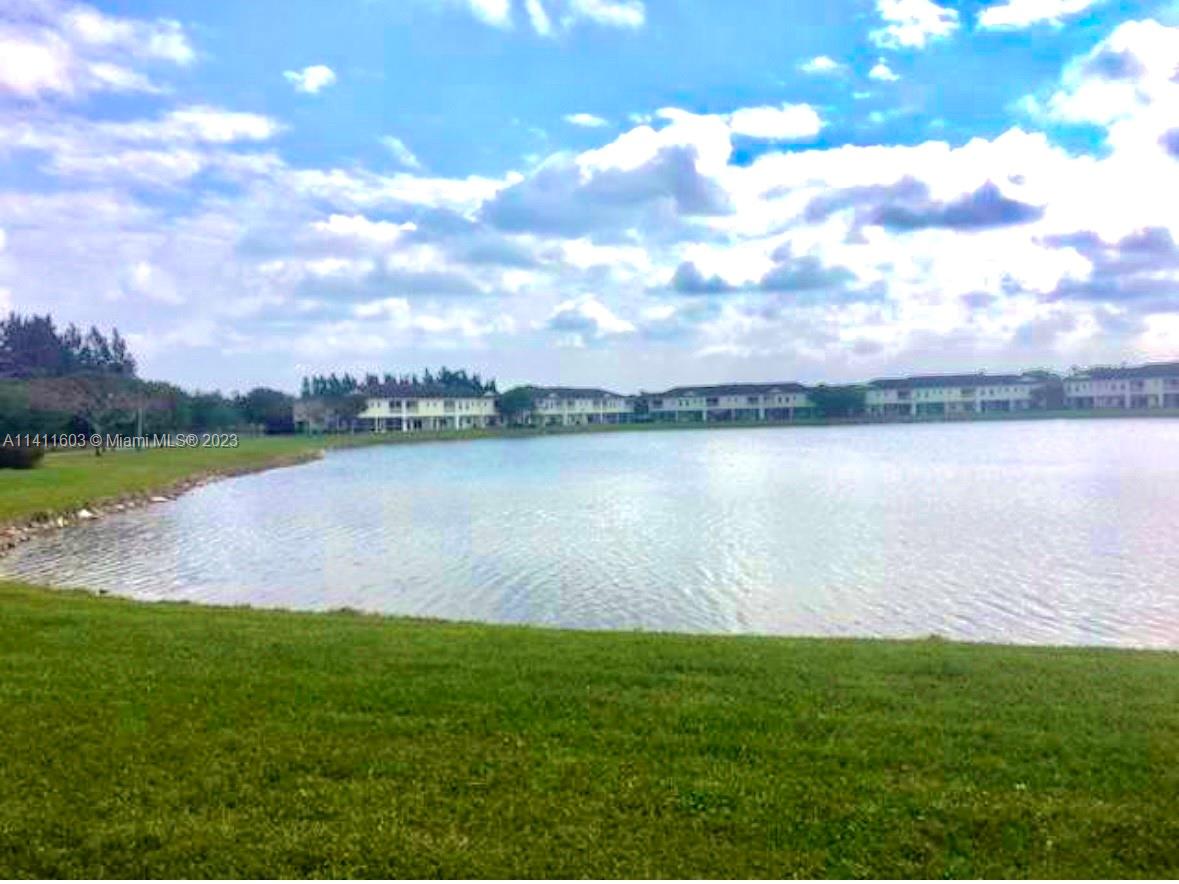 4322 Emerald Vista Lake Worth, FL 33461 - Photo 9 of 40 a view of a lake with houses in the back