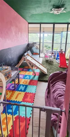 a room with furniture and a floor to ceiling window