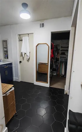 a room with water heater and a cabinet