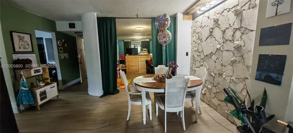 a dining room with furniture and a flat screen tv