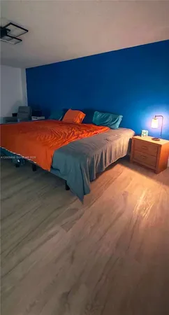 a bedroom with two beds and a night stand