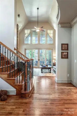 a view of entryway and hall with wooden floor
