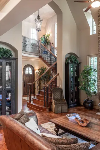 a living room with large pool table and chairs