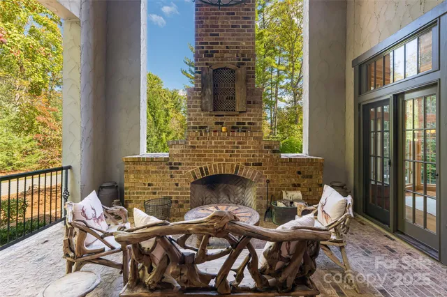 a living room with a fireplace and a floor to ceiling window