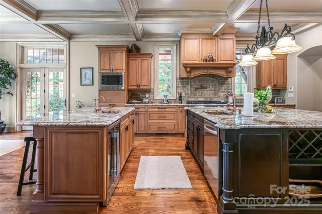 a large kitchen with stainless steel appliances granite countertop a stove and large cabinets