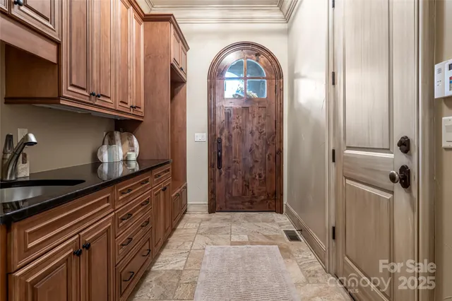 a view of a kitchen with stainless steel appliances granite countertop cabinets and a window