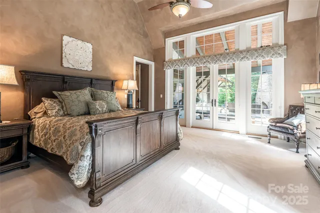 a spacious bedroom with a bed and glass door