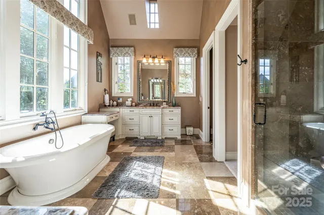 a spacious bathroom with a bathtub and a shower
