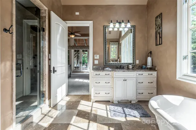 a spacious bathroom with a sink mirror and a shower