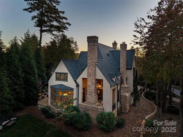an aerial view of a house with a mountain